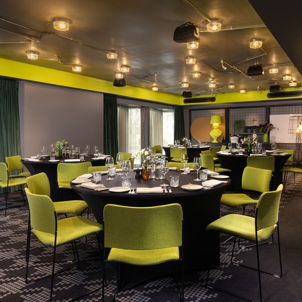 nhow_London_meeting_rooms_visual_lab_banquet_green_chairs_flowers_curtains_open_daytime