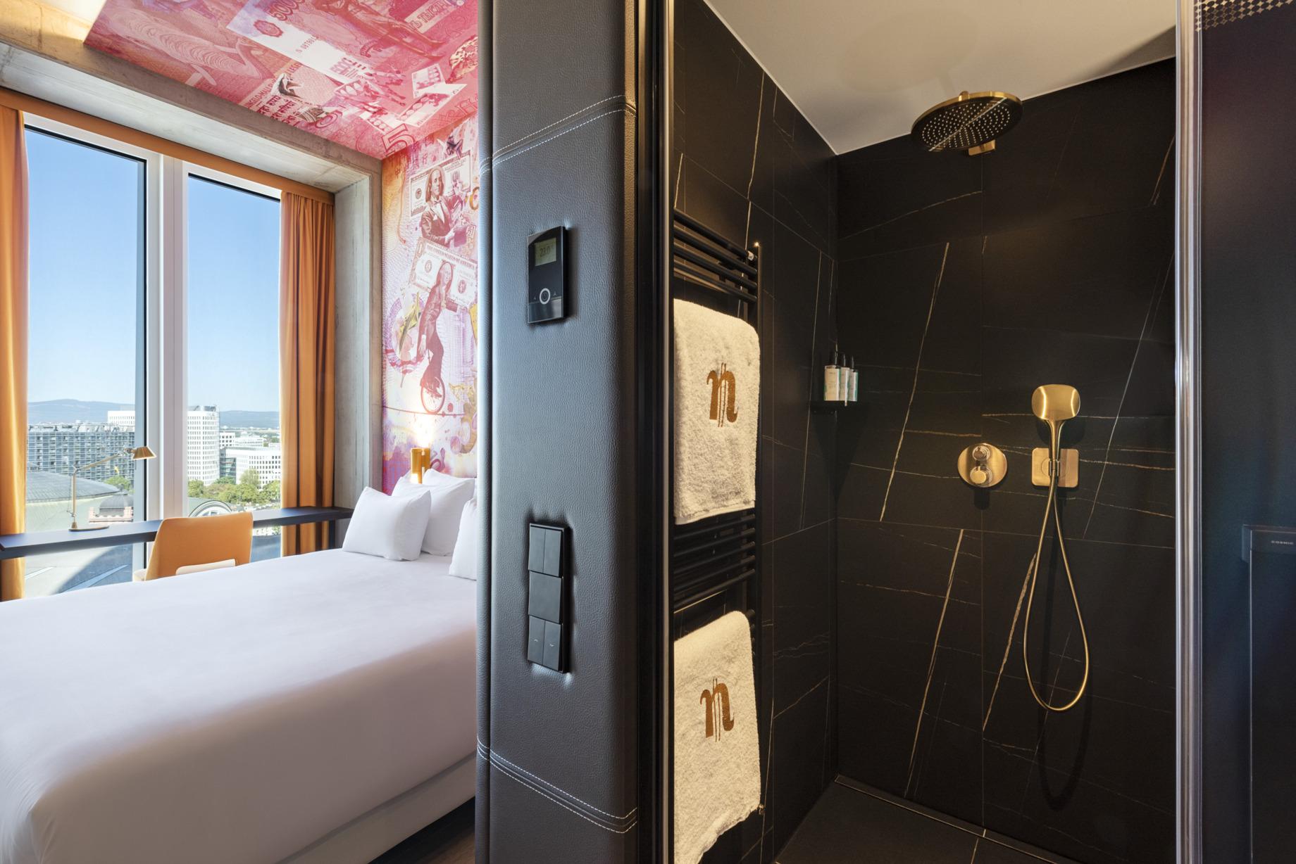 nhow_Frankfurt_Room_standard_curtains_open_king_size_bed_office_chair_shower_amenitie